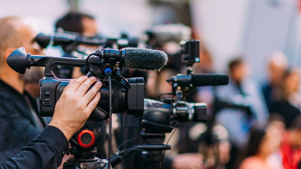 Group of Cameras at an Indoor Event