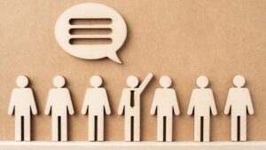 Wooden businessman with conversation concept